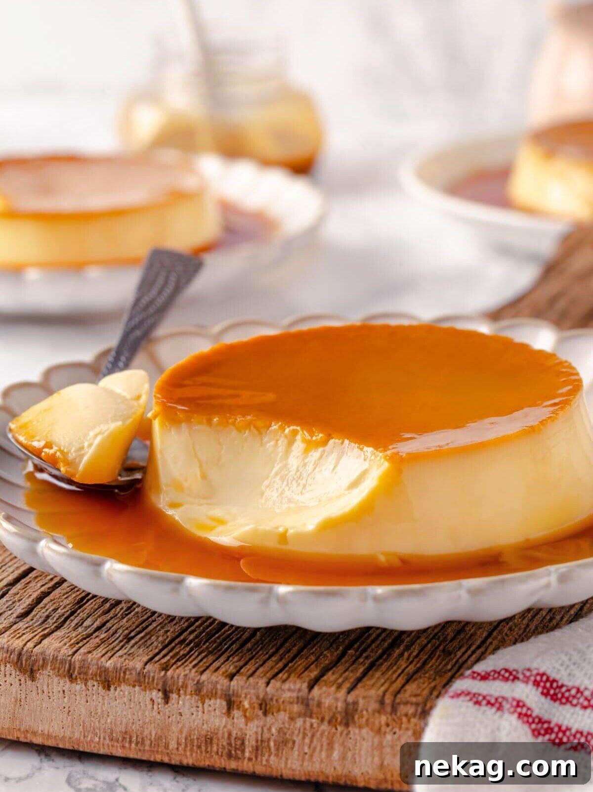 Silky Caramel Custard 17 A single serving of creme caramel with a silver spoon ready to dig in.