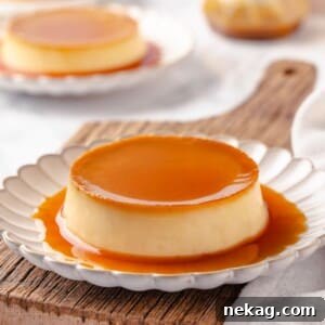 A single portion of creme caramel with a glossy amber caramel top served on a white plate.