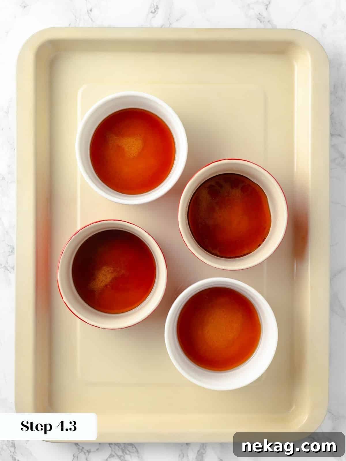 Silky Caramel Custard 9 Ramekins filled with caramelized sugar, ready for the custard to be added.