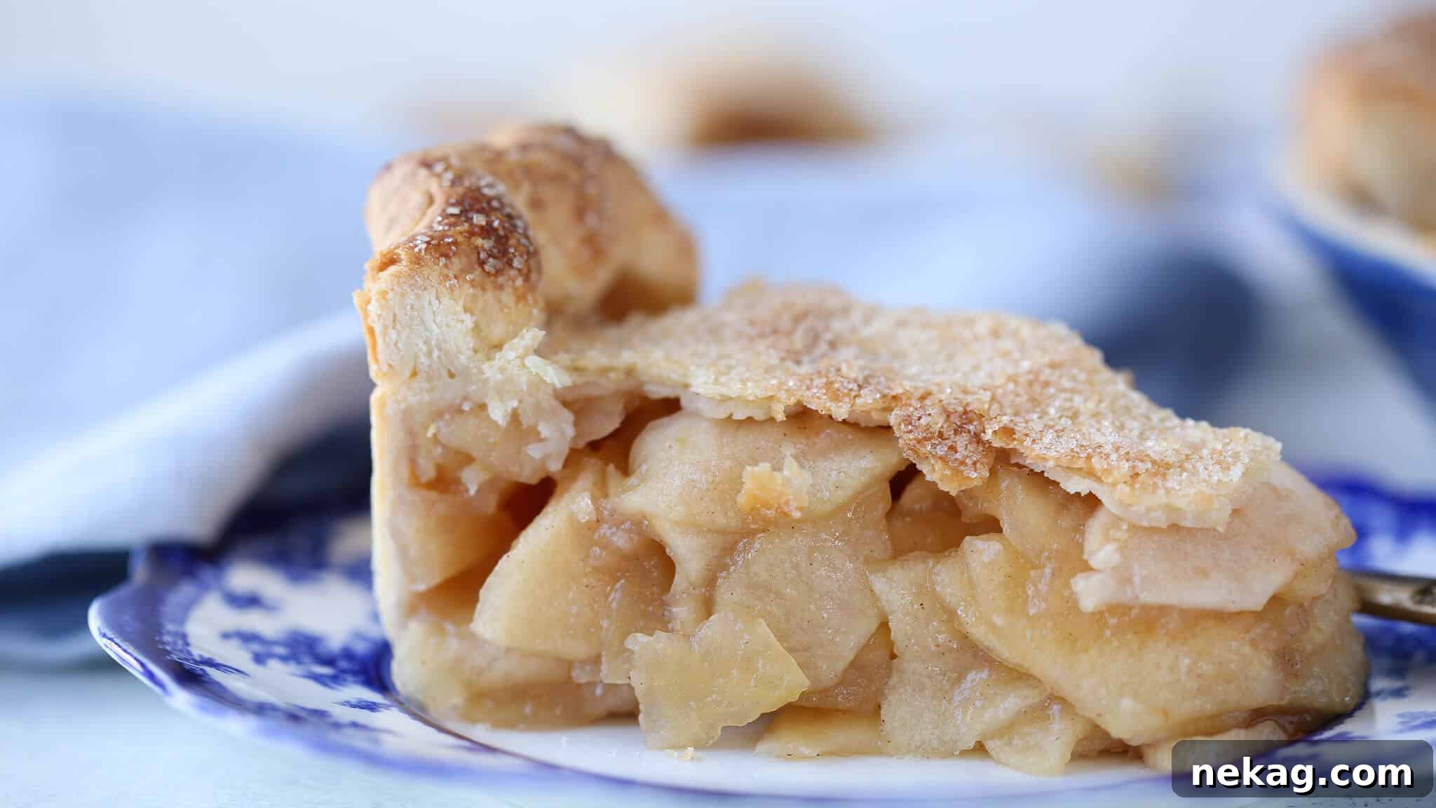 A side profile of the magnificent Mile High Apple Pie, highlighting its impressive height and golden crust.