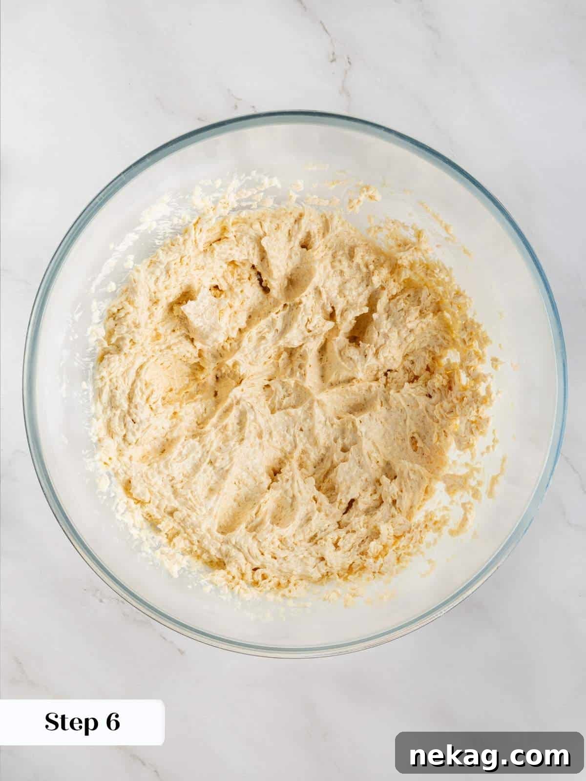 Cookie dough being mixed with eggs and vanilla extract for a rich, flavorful base.