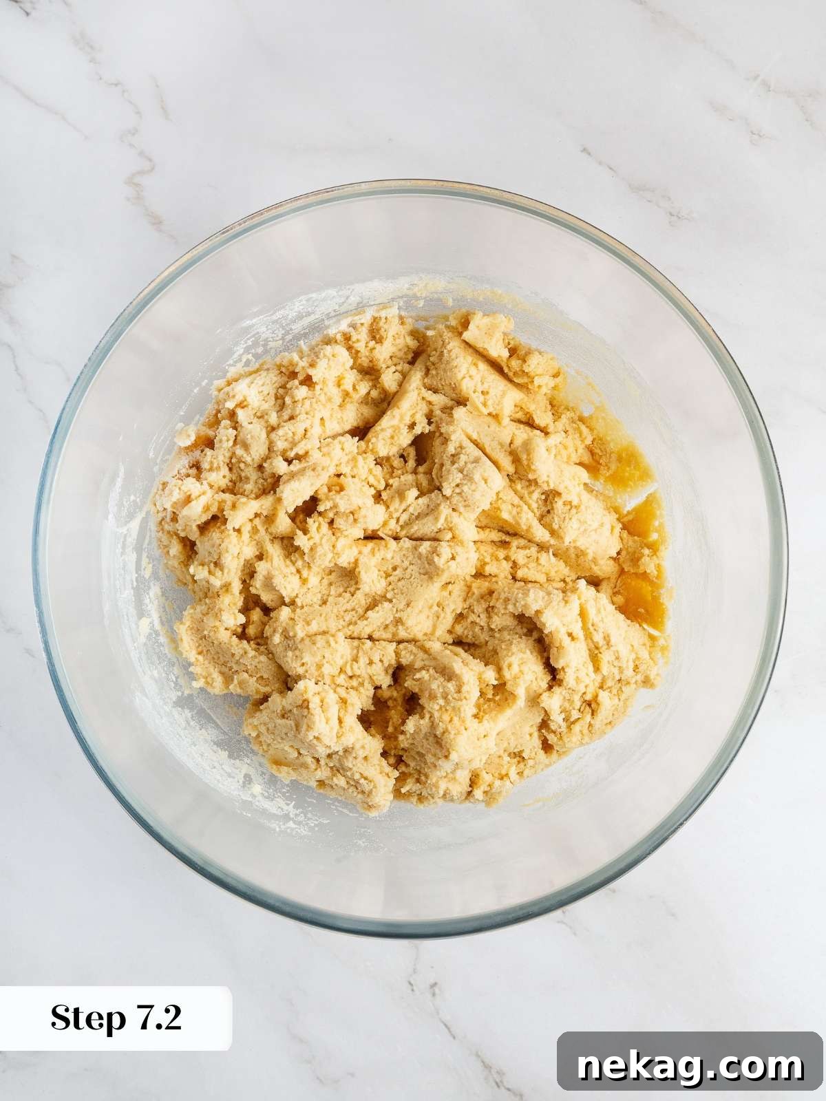 Cookie dough mixed with flour and dry ingredients, ready for the addition of raspberries and chocolate chips.