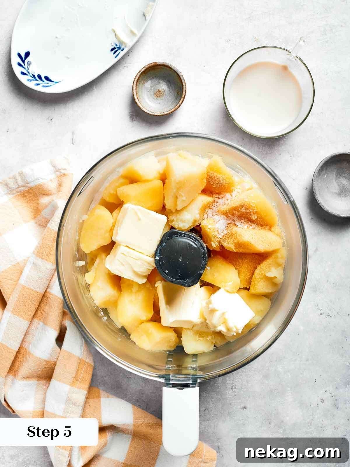Creamy mashed potatoes being whipped to perfection with a stand mixer, creating a smooth, fluffy texture for the topping.