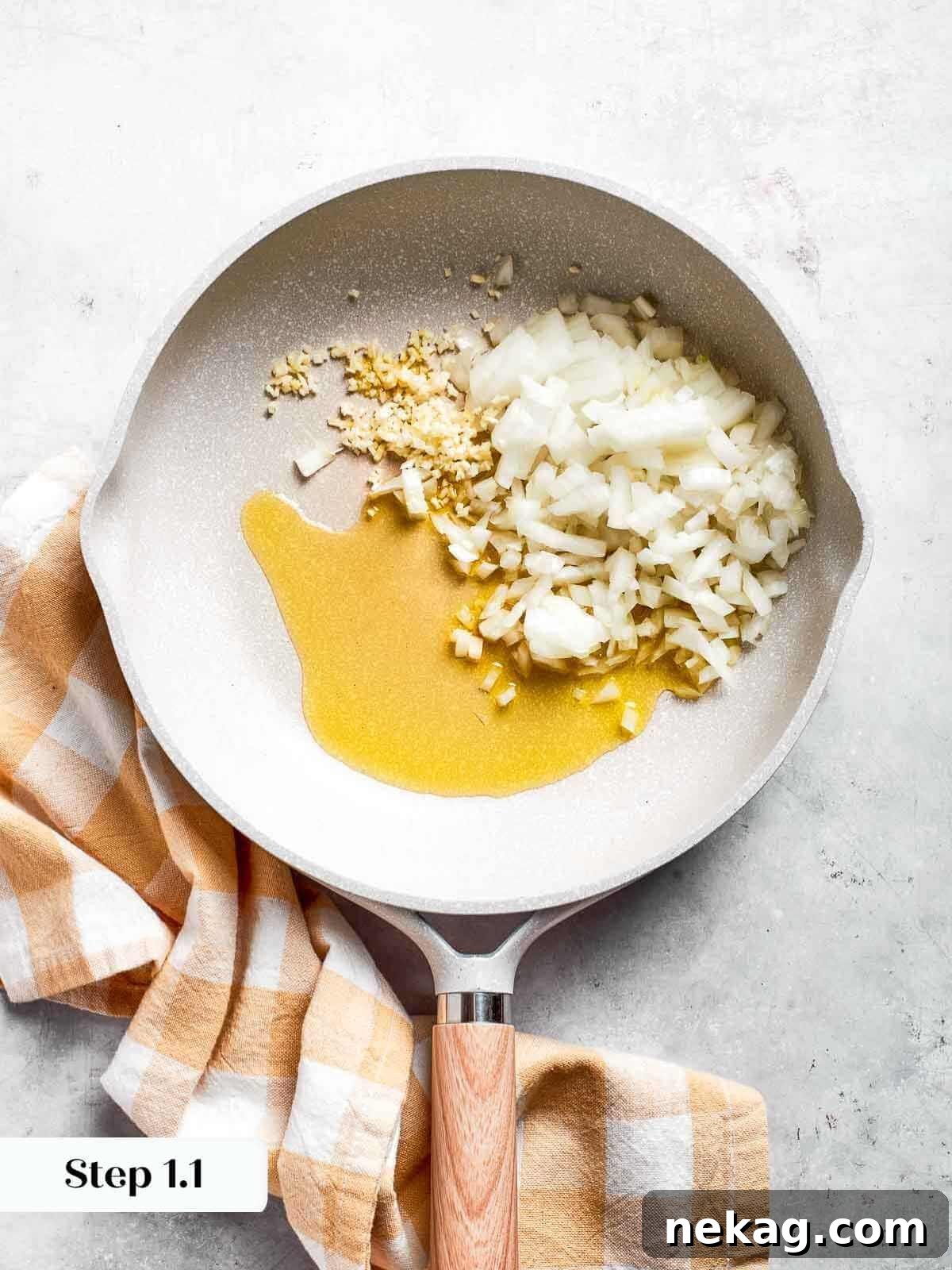 Finely chopped garlic and onions sizzling gently in a pan with olive oil, releasing a fragrant aroma as they become translucent.