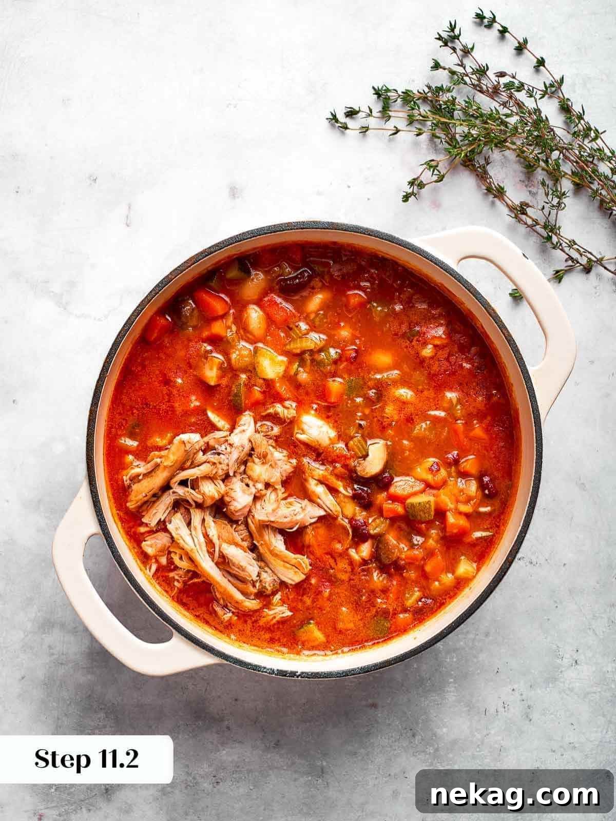 Freshly shredded chicken added back into the soup pot.