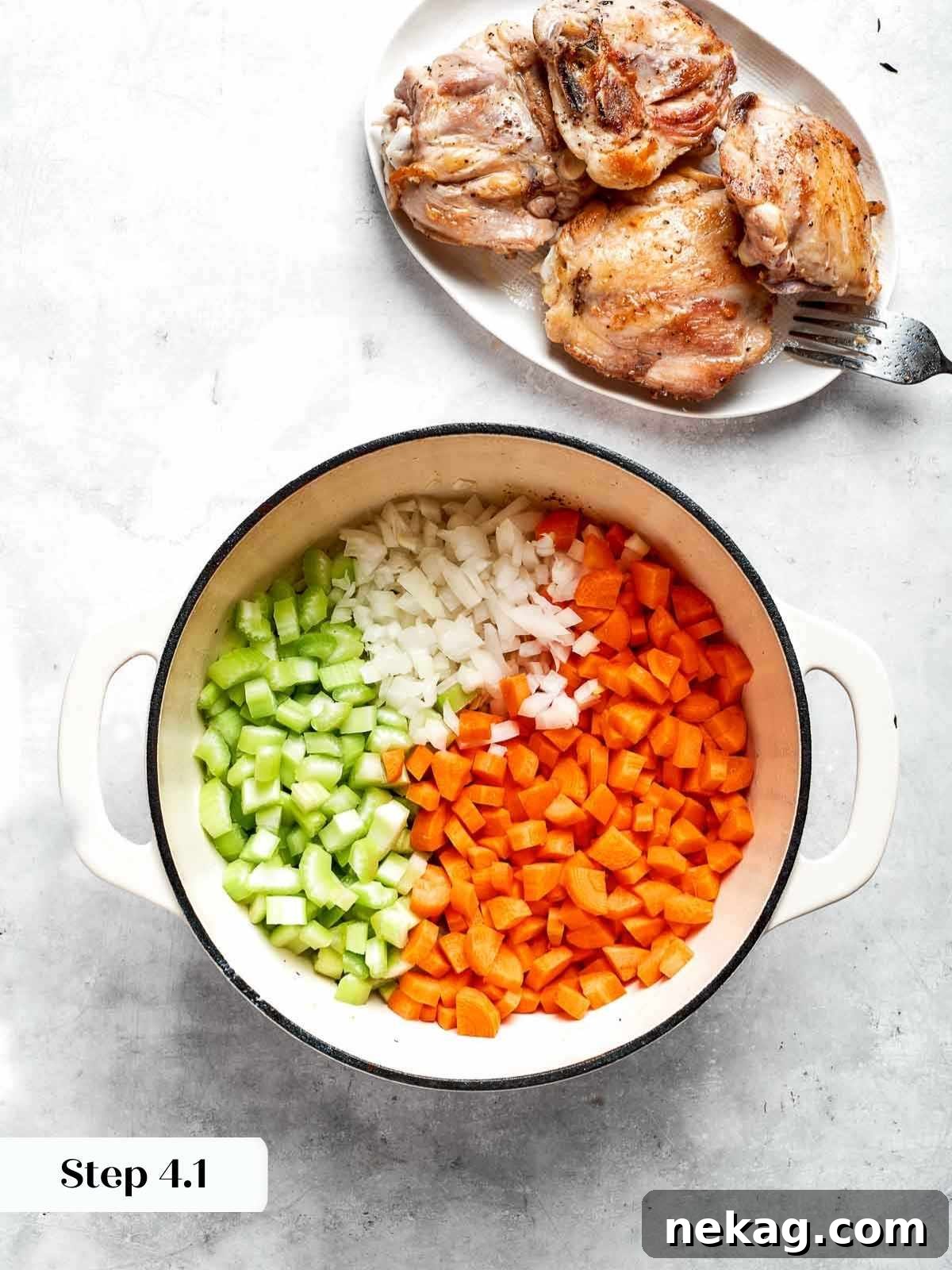Freshly diced carrots, onions, and celery added to the soup pot.