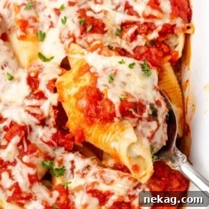 stuffed shell on spoon in dish.