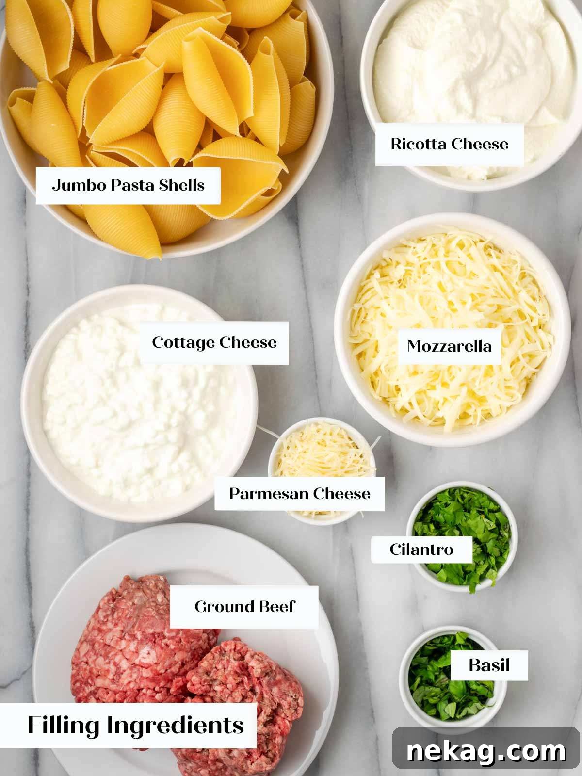 Hearty Meat-Stuffed Pasta Shells 4 Various fresh ingredients for stuffed shells, including cheeses, herbs, and ground beef, arranged on a marble counter.