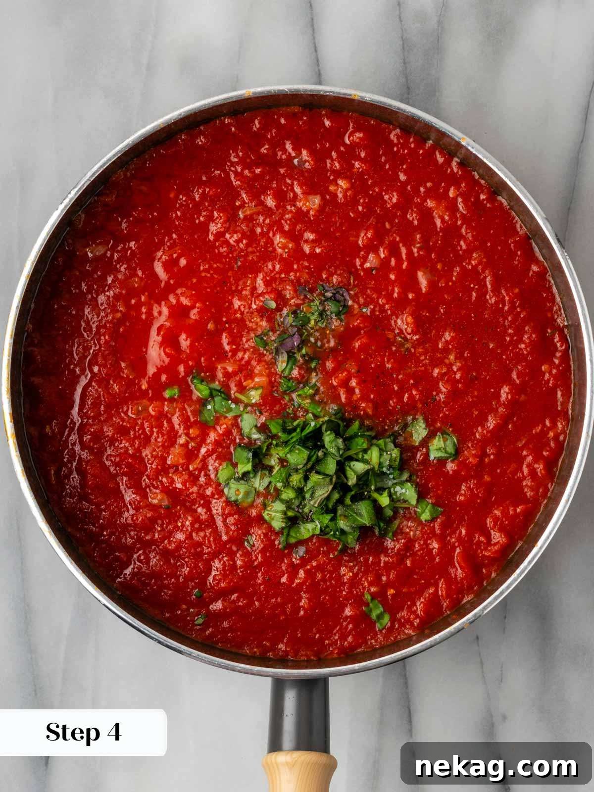 Hearty Meat-Stuffed Pasta Shells 8 A rich red sauce simmering in a pan, blending flavors of tomatoes, basil, and thyme.