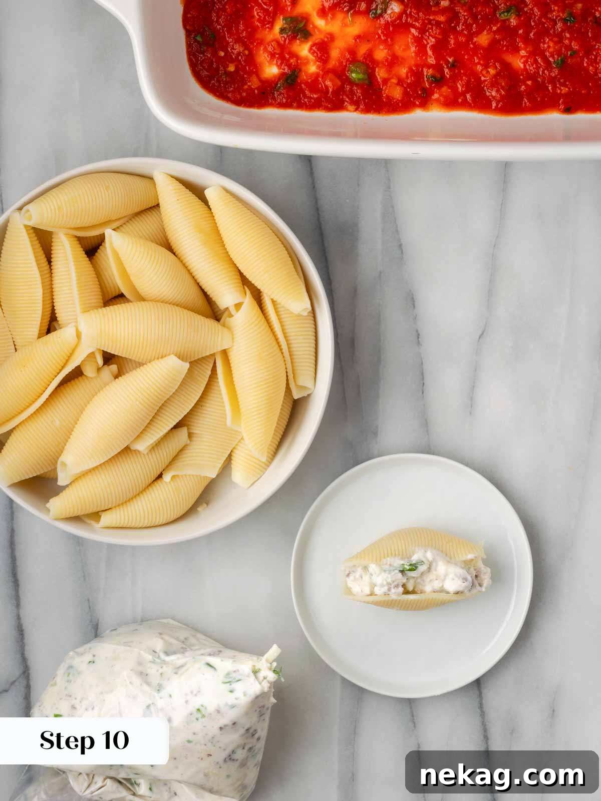 Hearty Meat-Stuffed Pasta Shells 10 A hand gently piping the meat and cheese filling into a jumbo pasta shell using a plastic baggie.