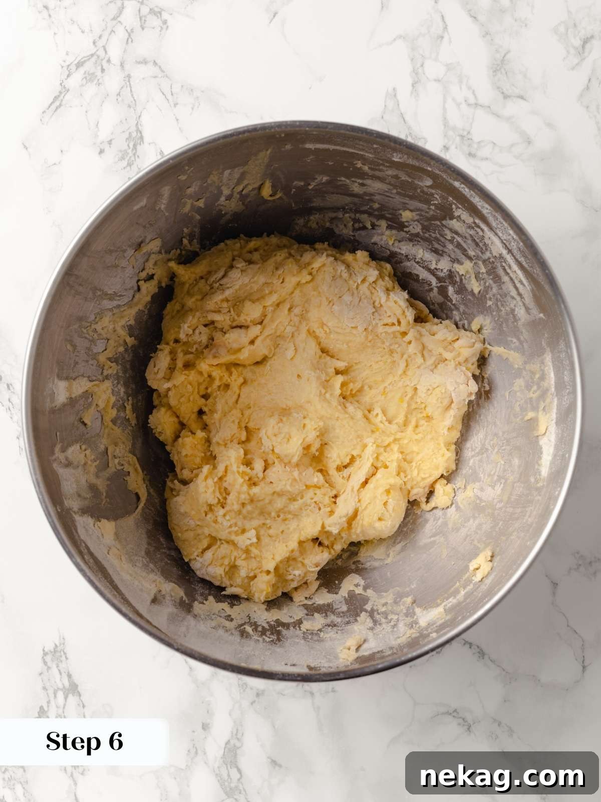 A close-up of dough forming into a soft, elastic texture.
