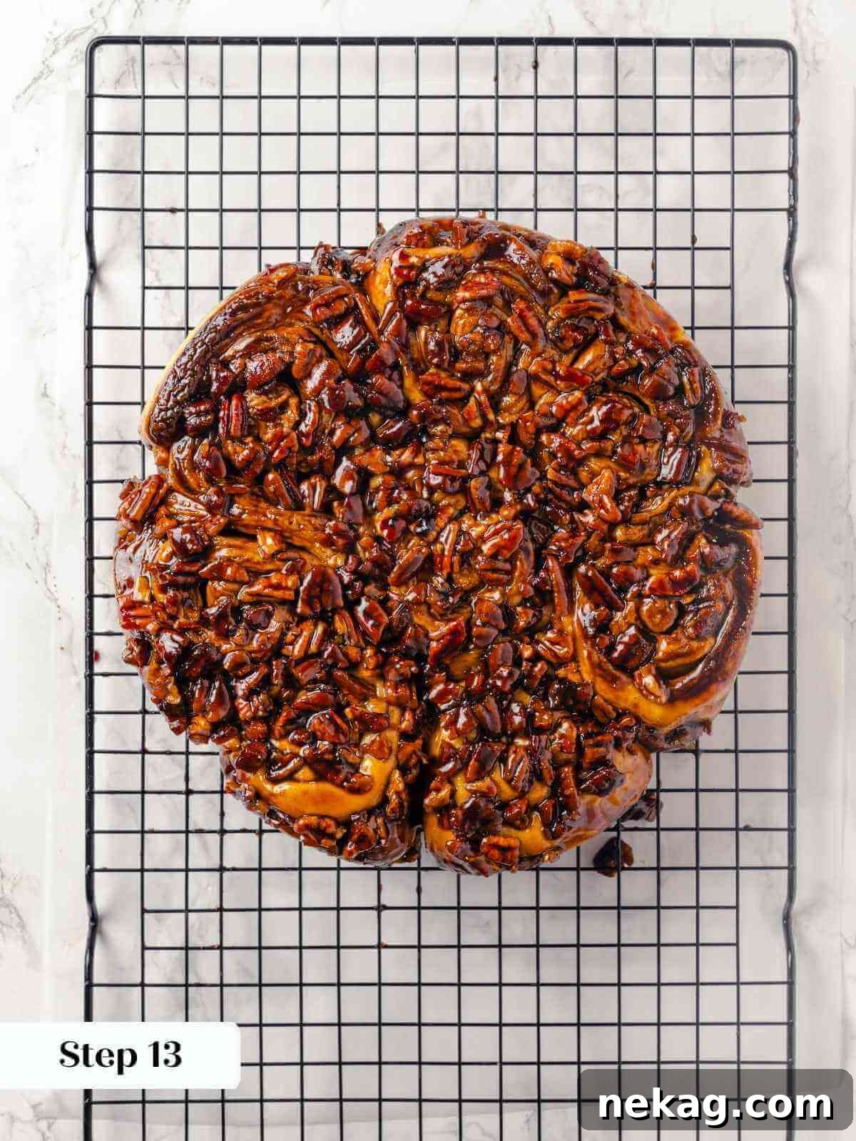 Sticky buns cooling on a wire rack after baking.