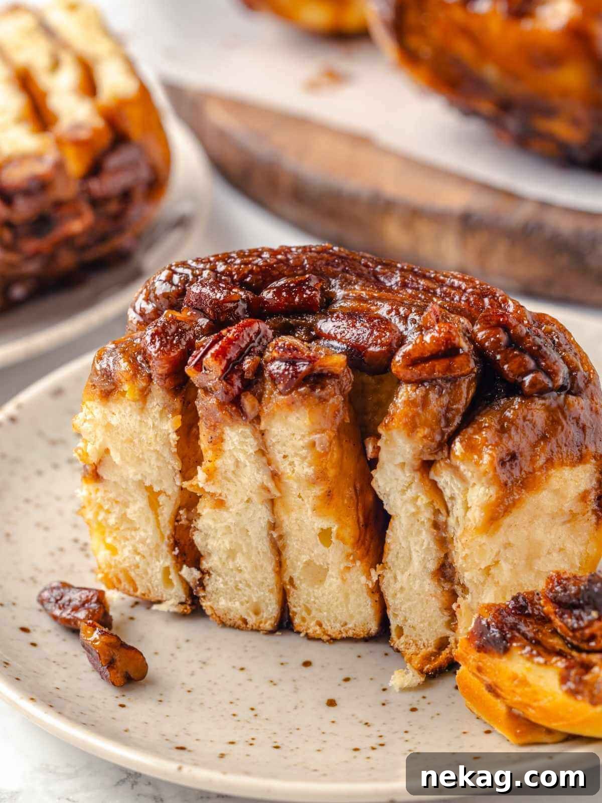 Gooey pecan sticky buns on a plate, ready to enjoy.