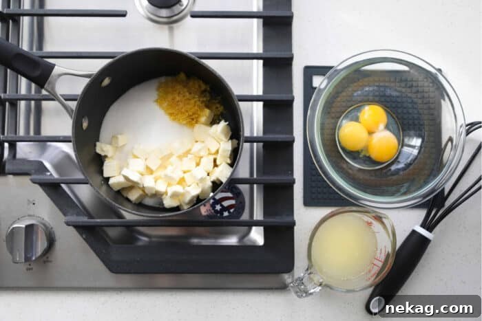 Homemade Lemon Curd Delight 5 Ingredients for making lemon curd laid out: granulated sugar, bright yellow lemon zest, fresh lemon juice, cubed butter, and separated egg yolks.
