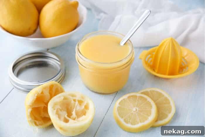 Homemade Lemon Curd Delight 9 A spoon resting inside a jar of homemade lemon curd, ready to be served or stored.
