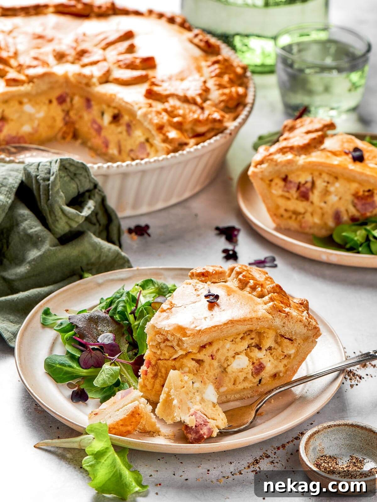 A neatly cut piece of deep-dish Italian Easter pie, showcasing its rich, layered filling of cheese and cured meats.