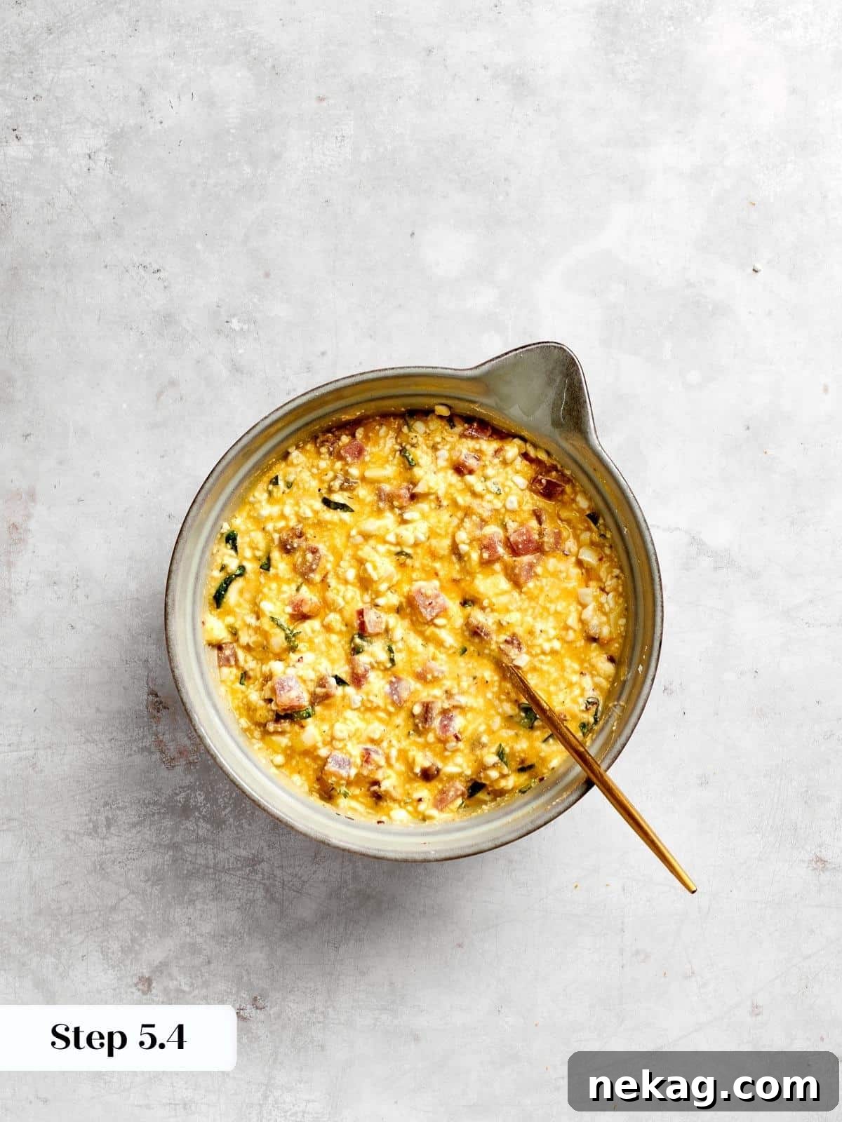 A creamy, cheesy, and savory filling mixture, perfectly prepped and ready to be spooned into the awaiting pie crust with ease.