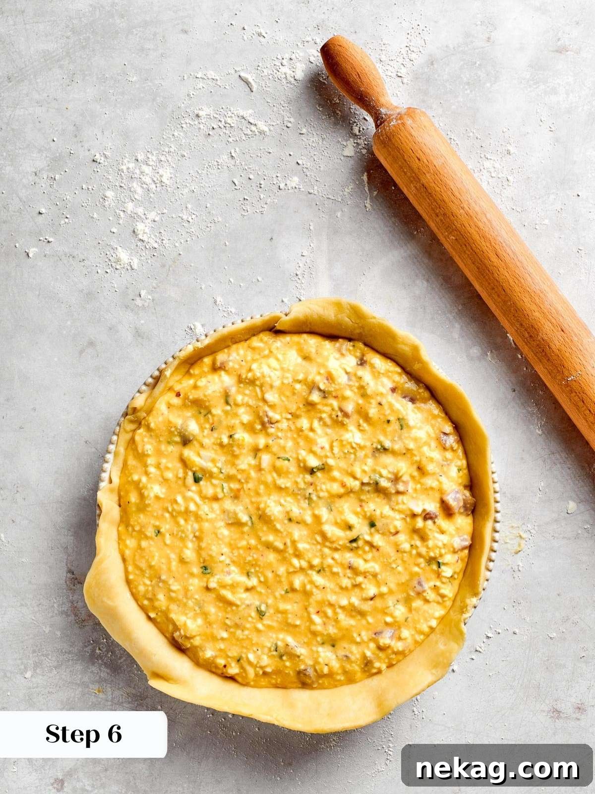 A springform pan generously filled to the brim with the savory ingredients of pizza rustica, meticulously layered within the tender pastry crust.