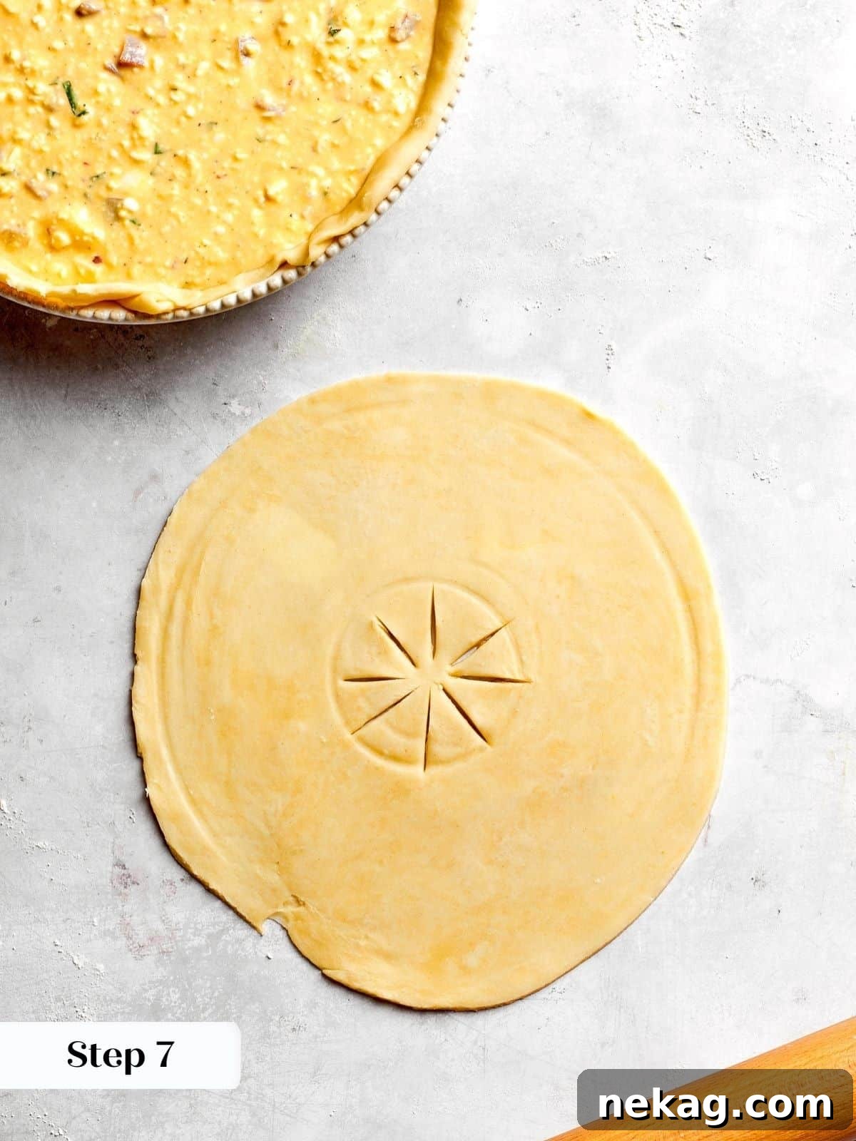 A pie crust with carefully cut slits, or vents, strategically placed to allow steam to escape efficiently during the baking process, preventing sogginess.