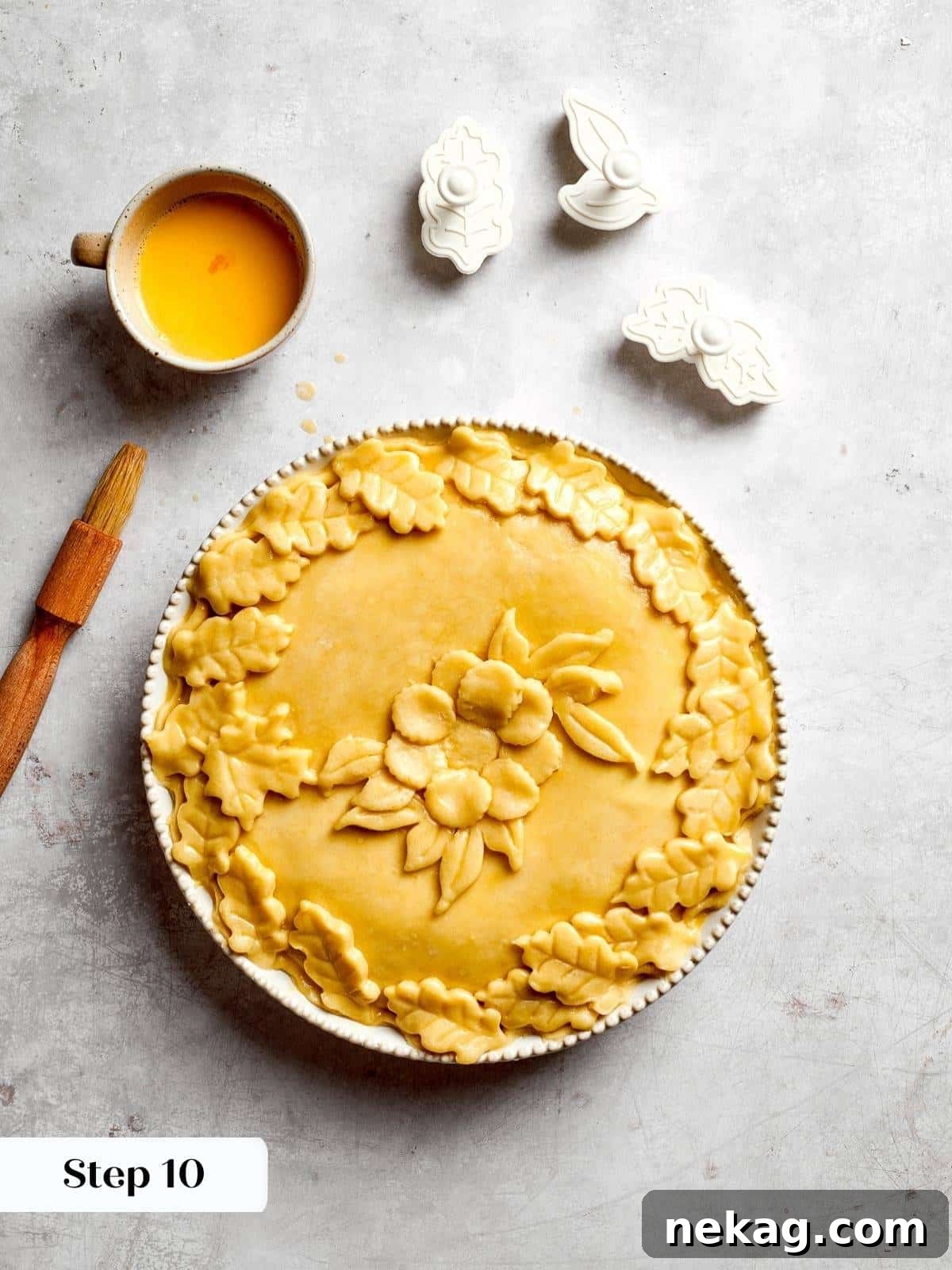 The fully assembled pizza rustica, with its decorative top crust and meticulously crimped edges, perfectly ready to be placed into the oven for baking.