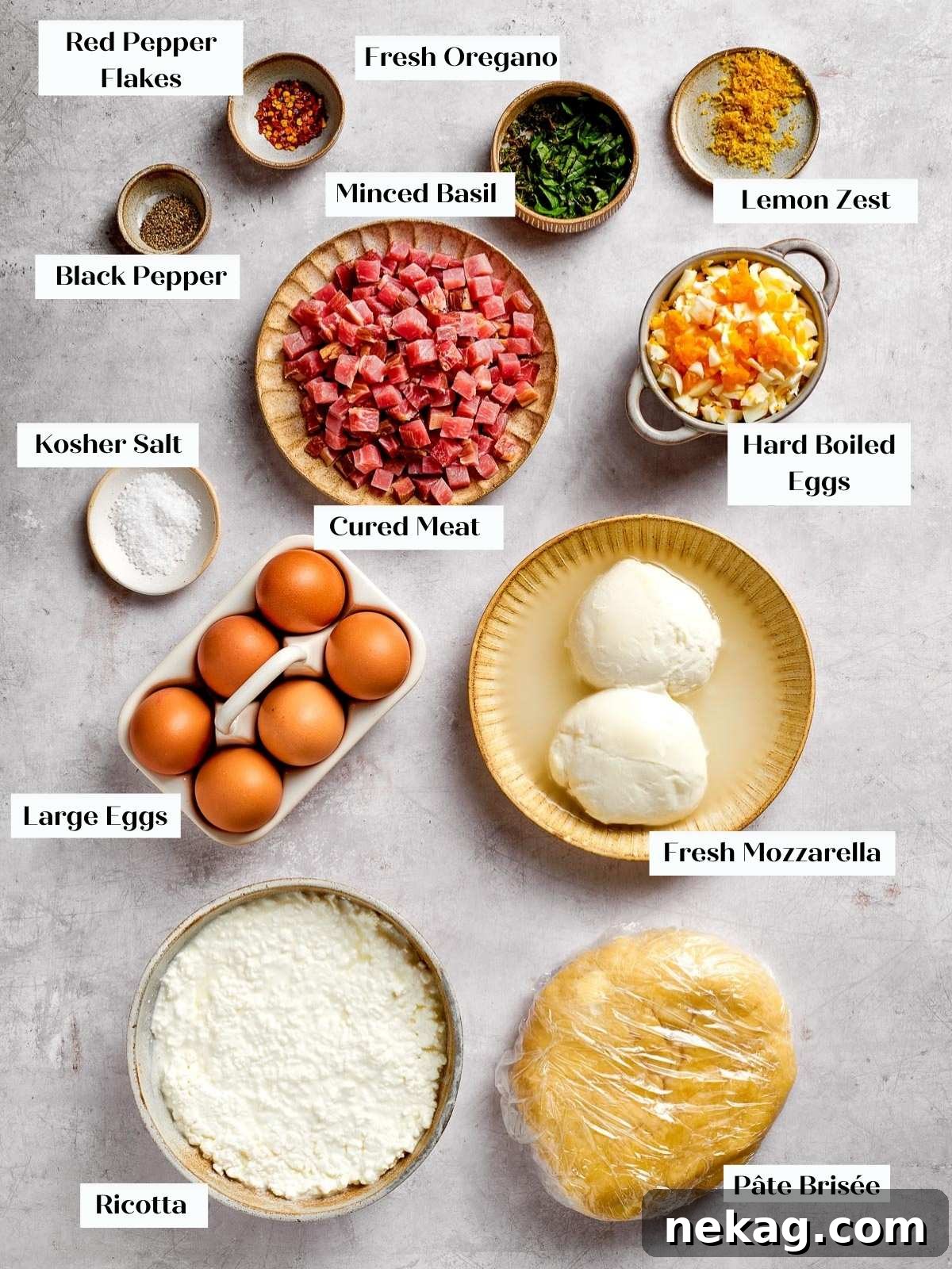 Fresh ingredients for pizza rustica, including cheeses, meats, and herbs, neatly spread out on a kitchen countertop, ready for preparation.
