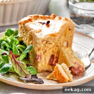 A beautifully plated slice of pizza rustica with a perfectly golden crust and a creamy, cheesy filling, delicately garnished with fresh herbs.