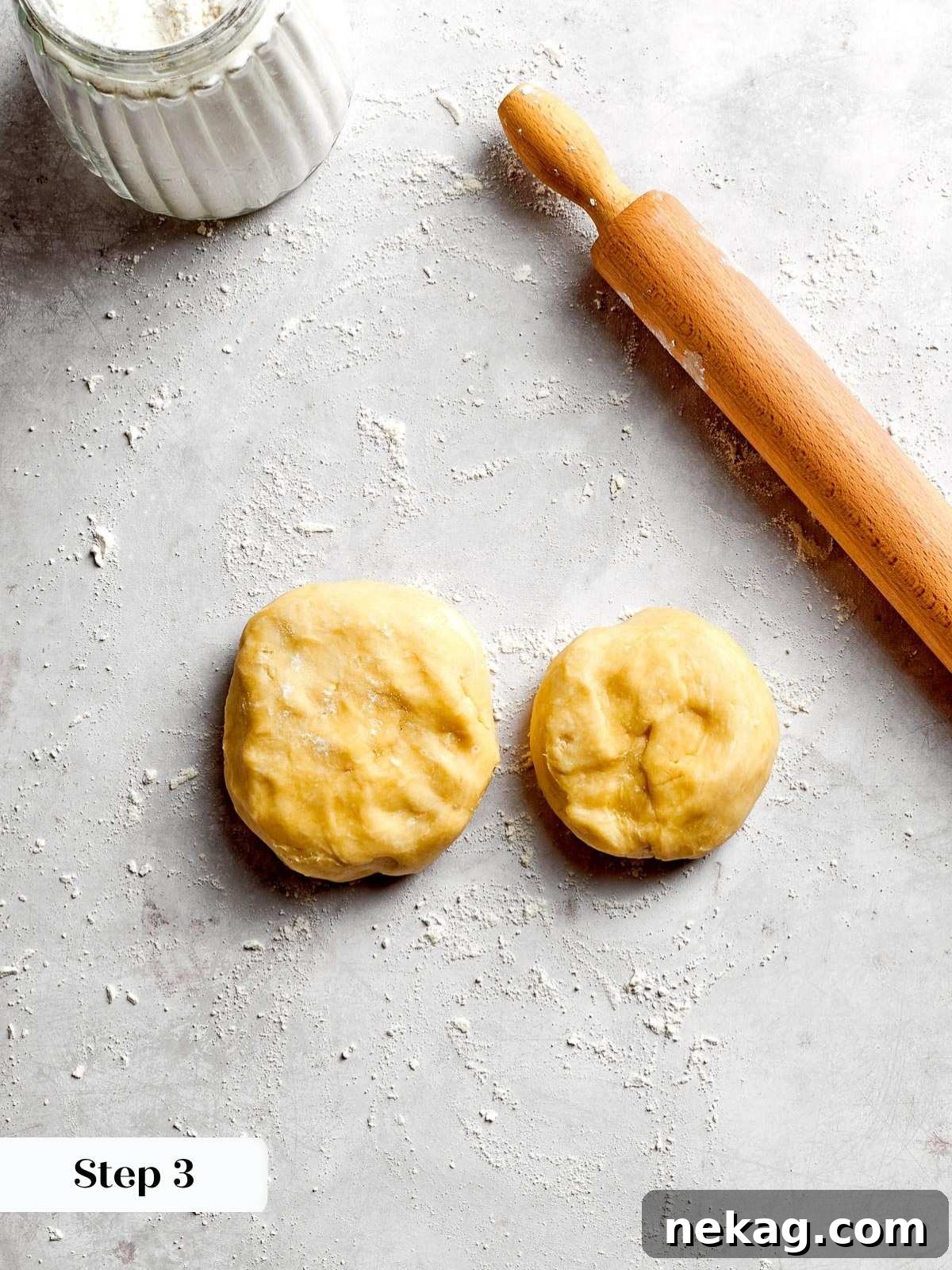 The pie dough perfectly portioned into two distinct pieces: one larger portion designated for the bottom crust and a smaller portion for the elegant top crust.