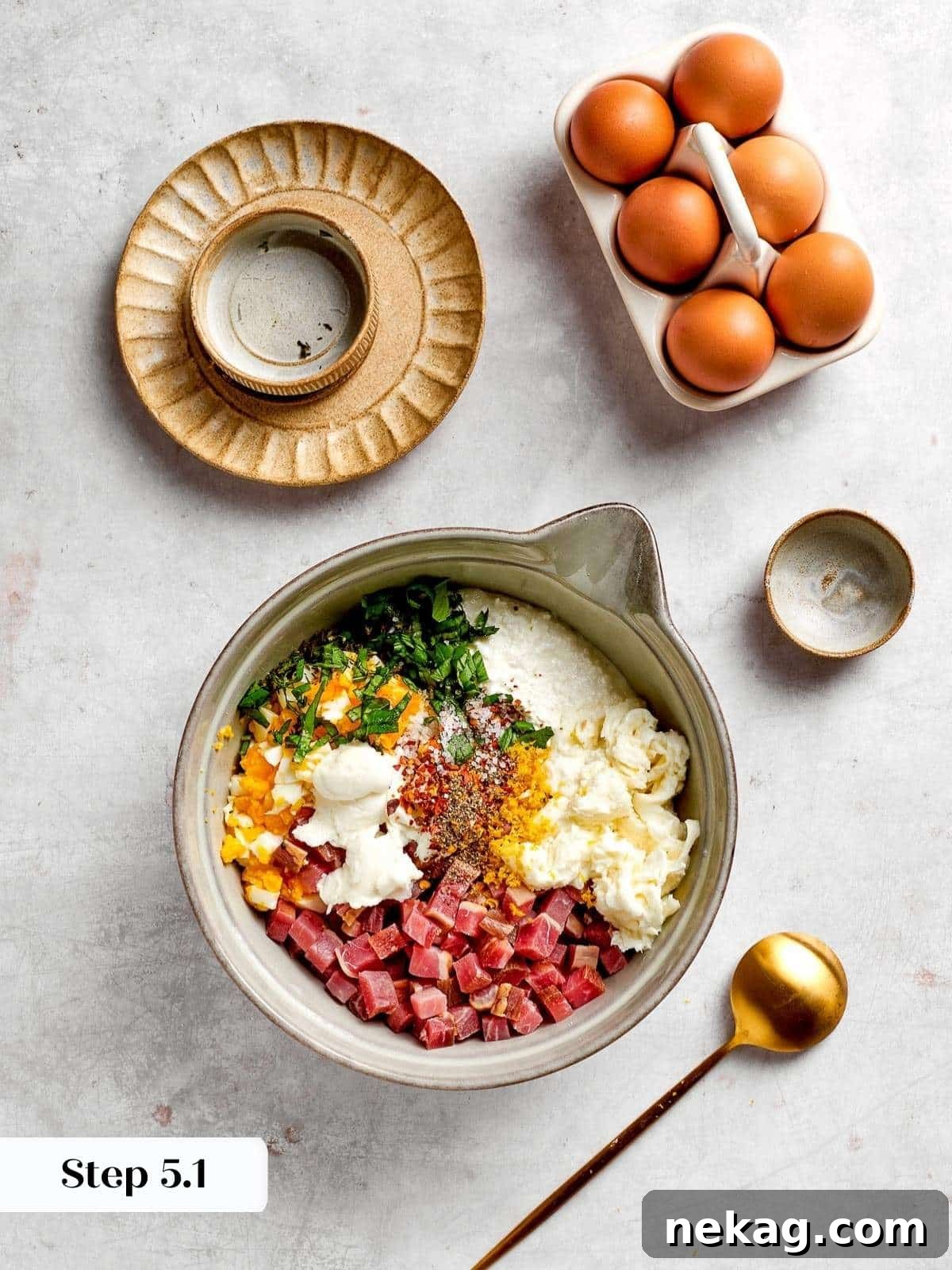 The initial stage of the pizza rustica filling, showcasing fresh ingredients like creamy ricotta, aromatic herbs, and savory cured meats, all unmixed in a bowl.