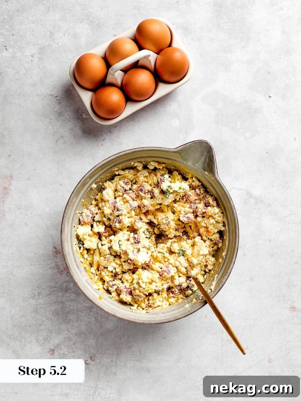 The pizza rustica filling, thoroughly mixed together with all ingredients except the eggs, showing a harmonious and even distribution.