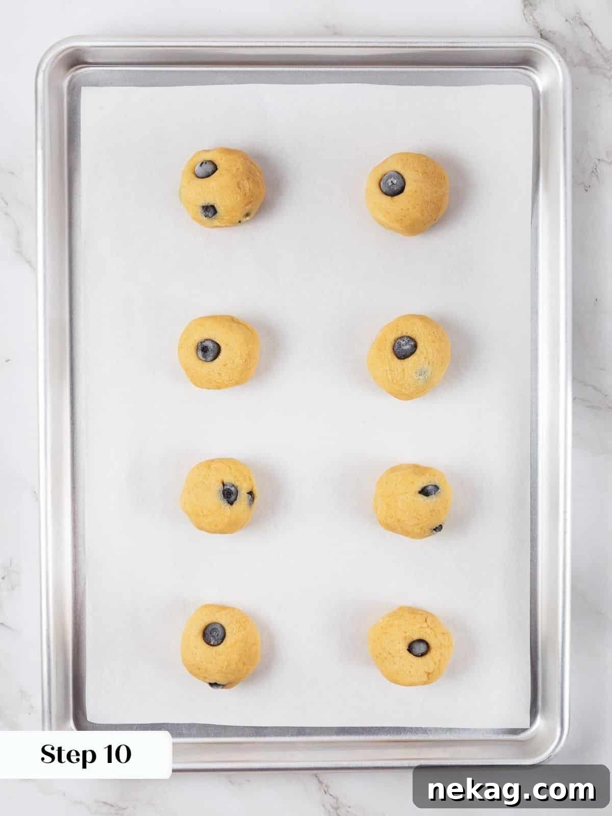 A tray of chilled lemon blueberry cookie dough balls ready to be placed in the oven.