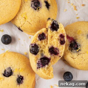 A close-up showing the chewy texture of a lemon blueberry cookie, enticingly delicious.