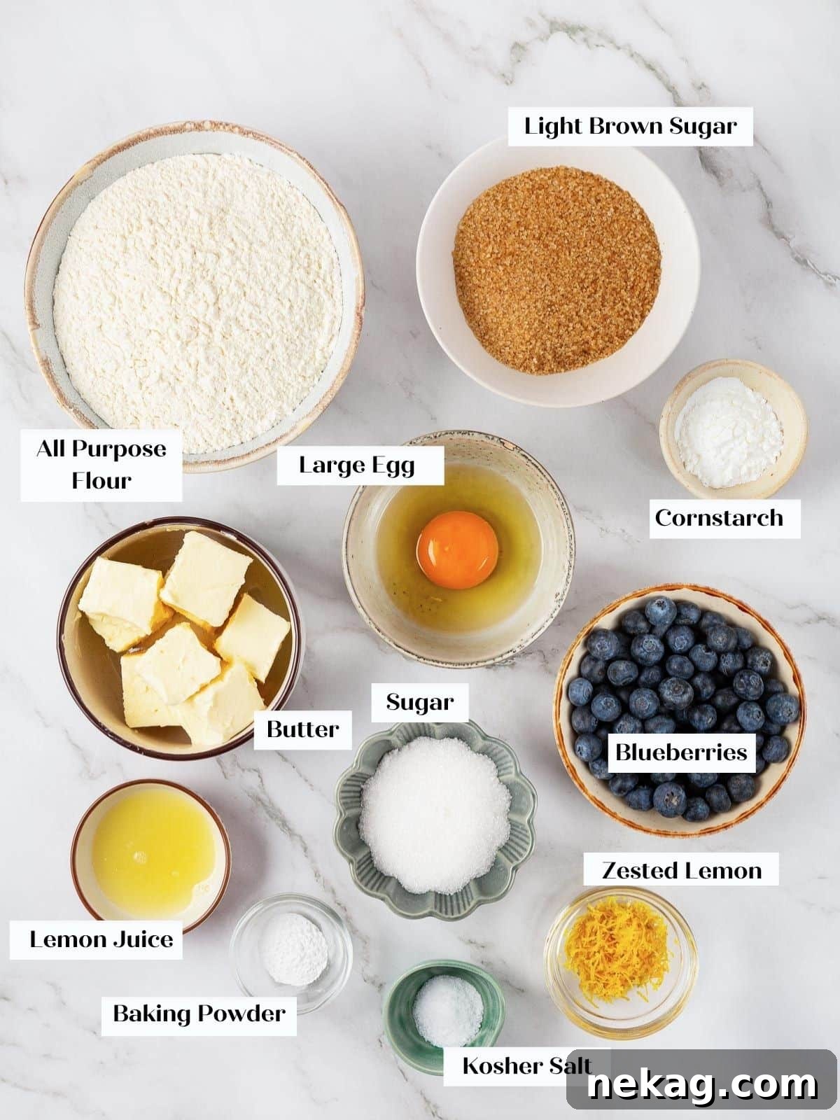 All ingredients for lemon blueberry cookies arranged on a kitchen counter, ready for baking.