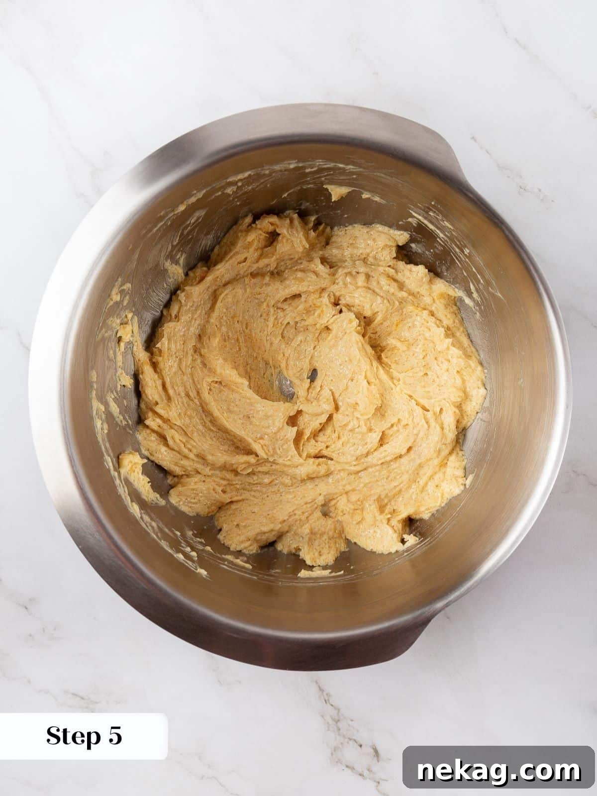 A bowl of dough with lemon juice just added, showing the slight curdling before fully mixing.