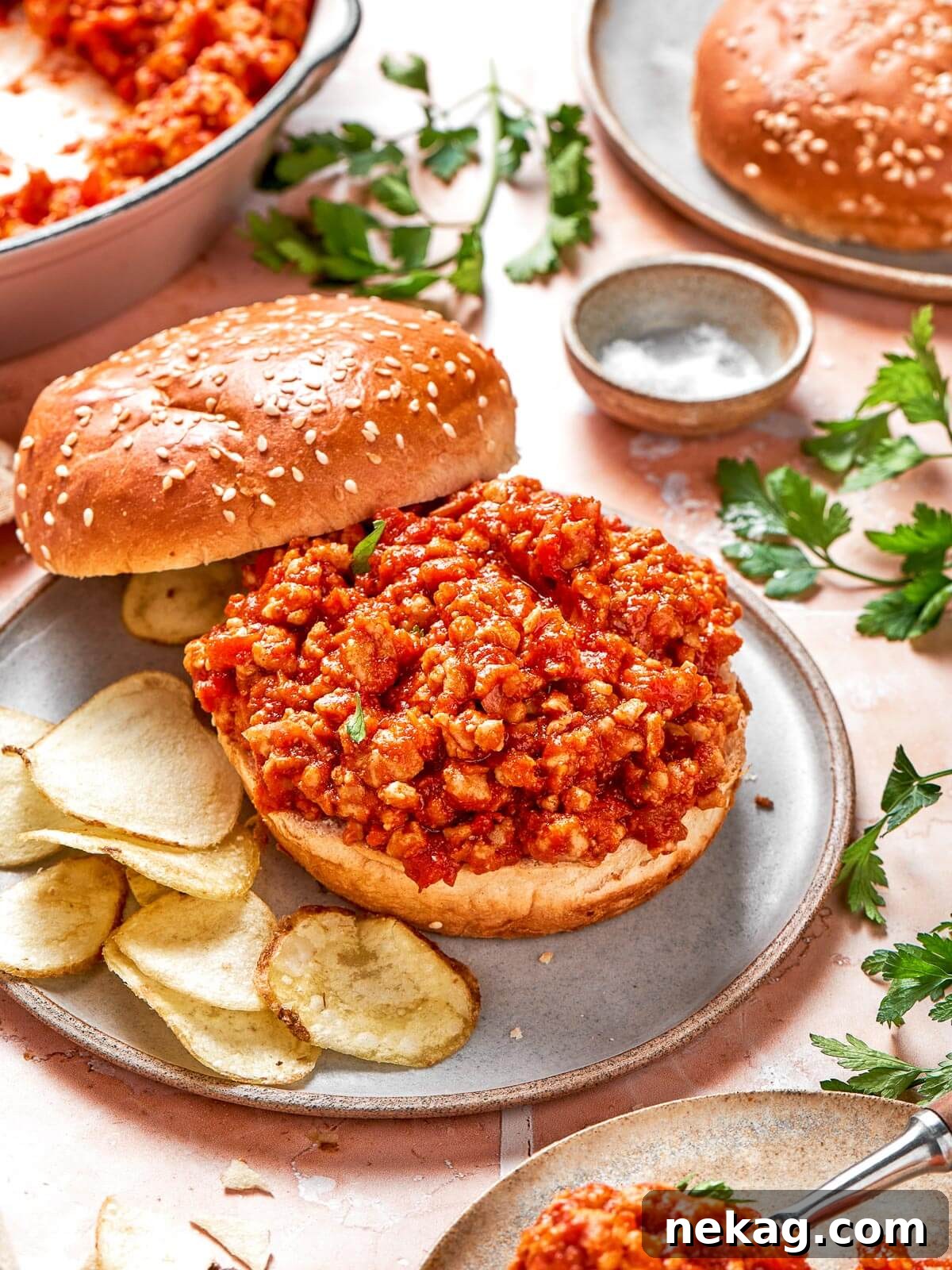 A family-style presentation of turkey sloppy joes in a large skillet, ready for everyone to serve themselves.