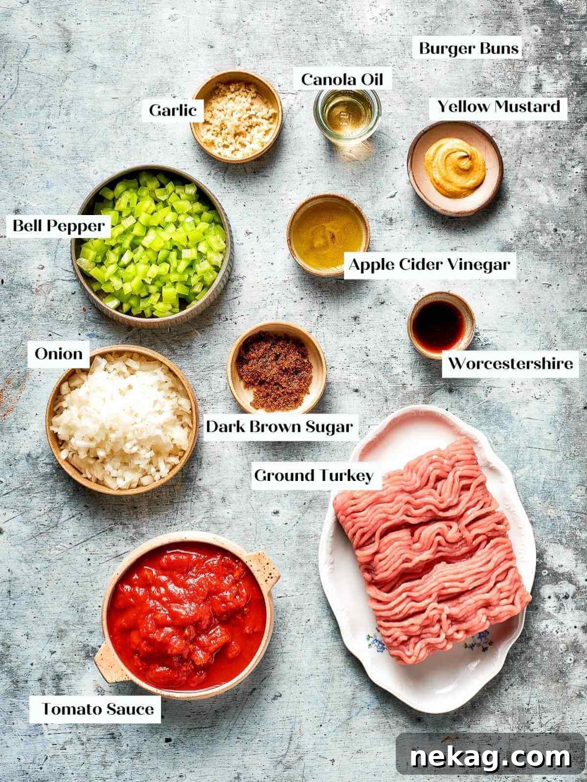 All the fresh and pantry ingredients for making turkey sloppy joes laid out neatly on a kitchen counter.
