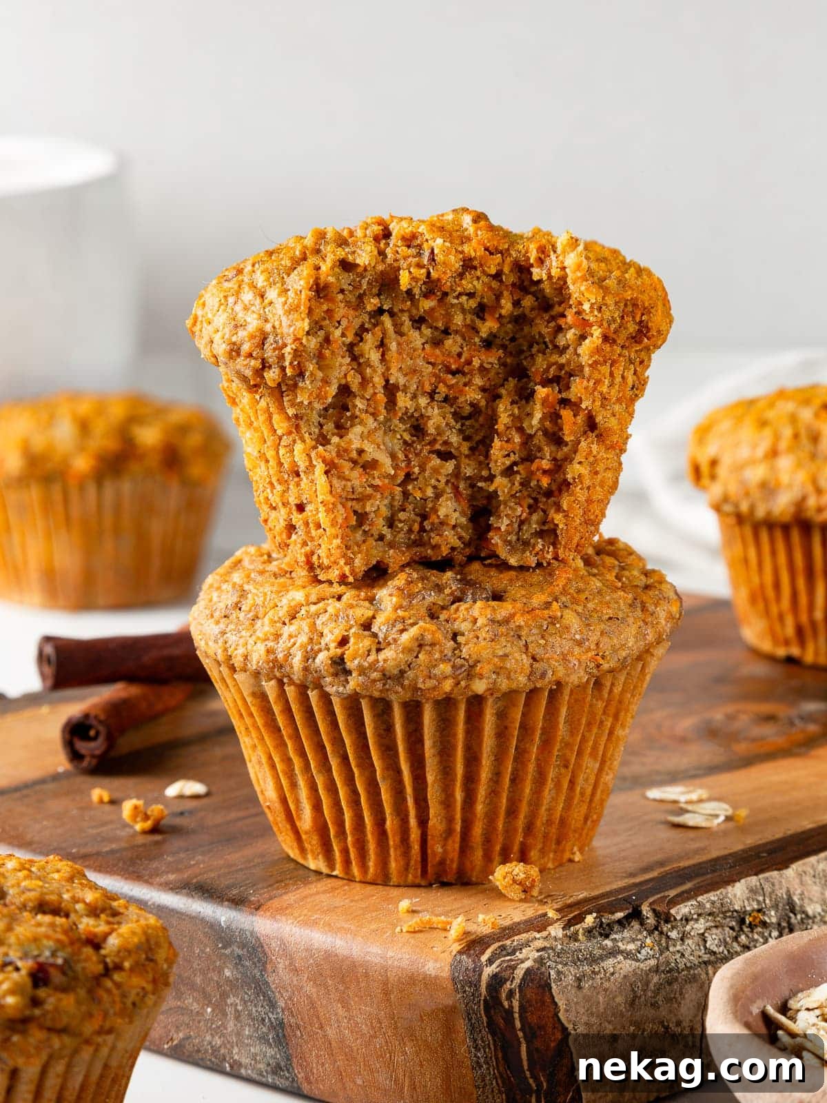 Partially eaten healthy carrot muffin revealing its soft, moist, and tender center, packed with visible carrot shreds and a wholesome texture.