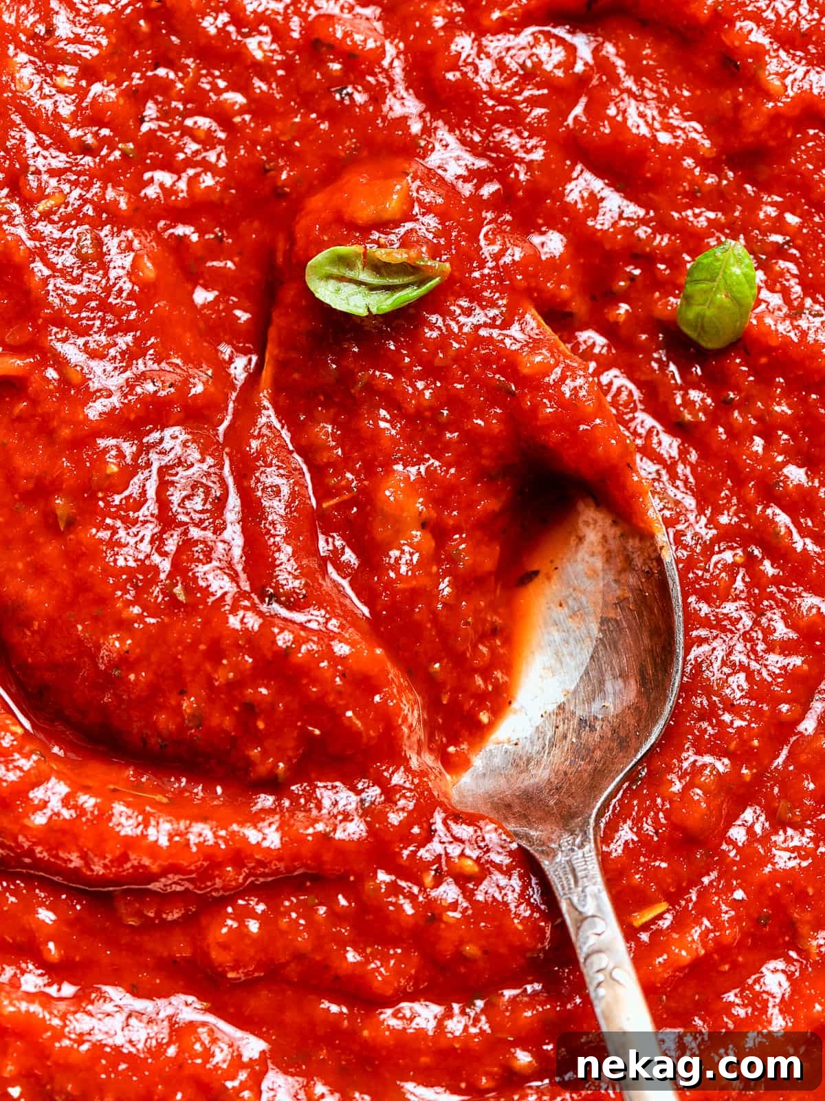 Vivid red homemade pizza sauce with a glossy finish, ready to elevate any pizza.