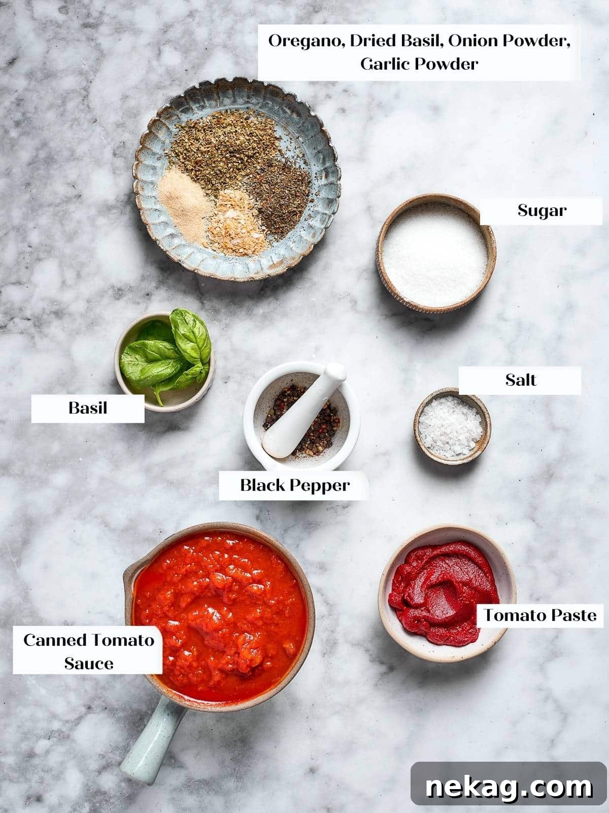 Dried herbs and tomato products prepped for homemade pizza sauce, neatly arranged on a countertop.