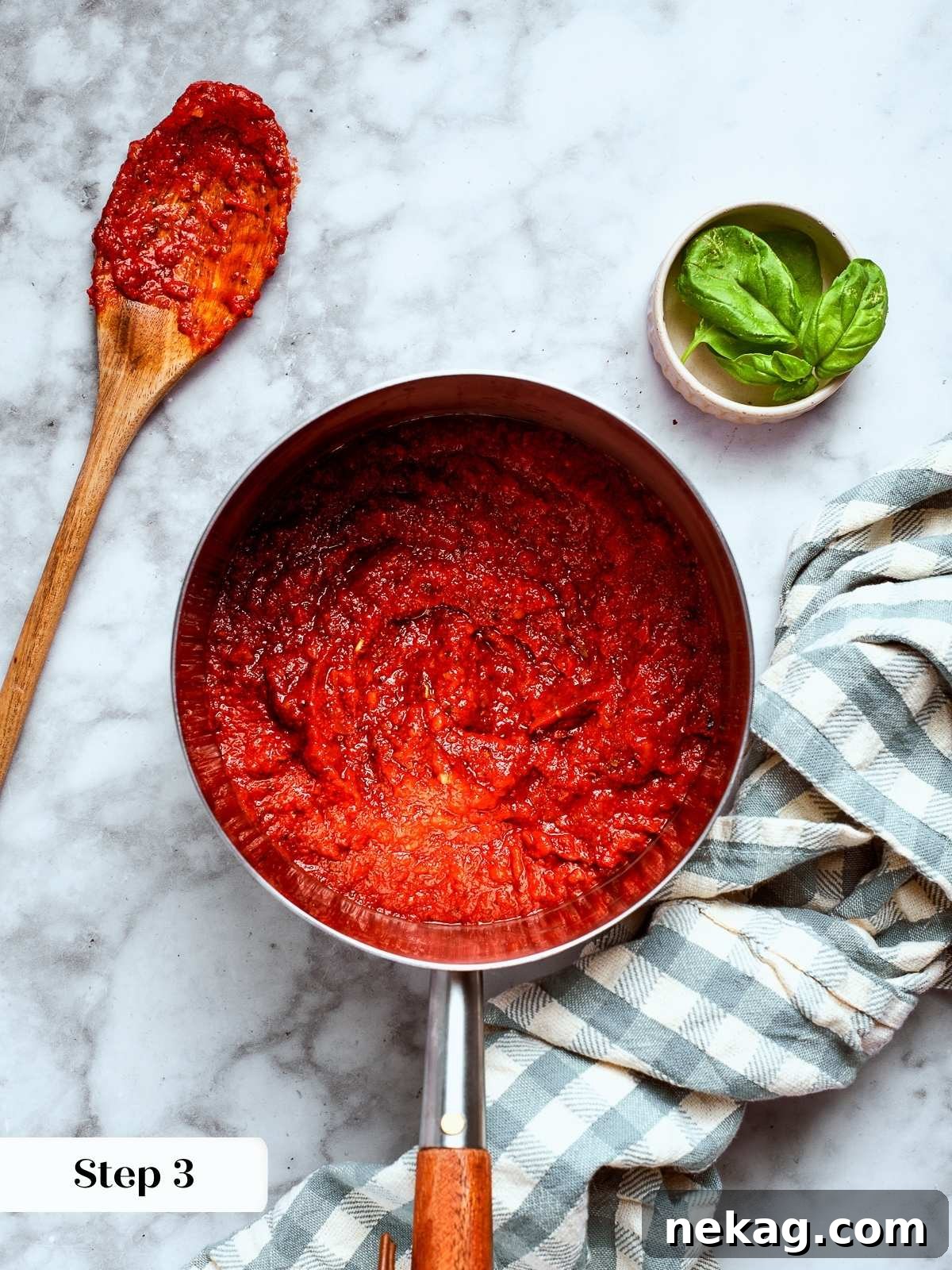 A small spoonful of sauce next to a saucepan for tasting, demonstrating the critical adjustment step.