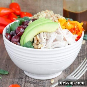 Quinoa Kale Power Bowl with roasted chicken, avocado, bell peppers, and grapes.