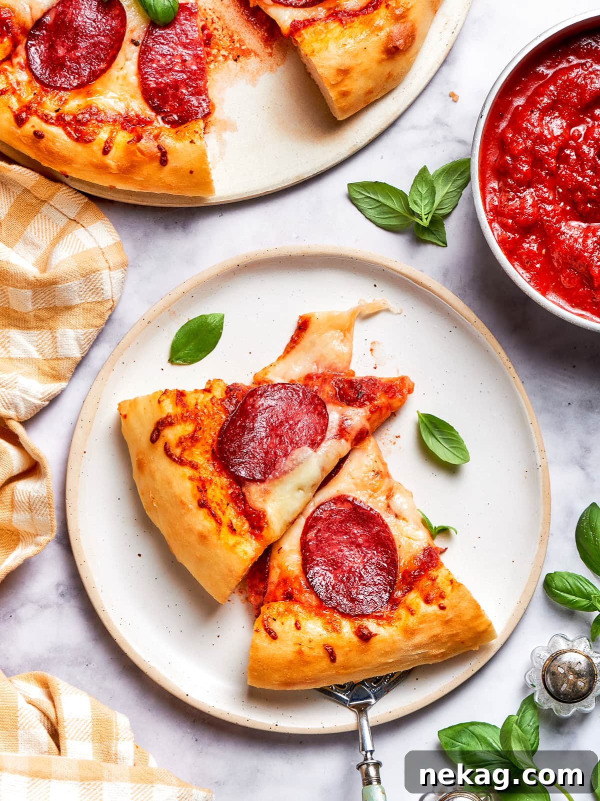 A pair of perfectly baked pizza slices, showcasing melted cheese, crispy crusts, and vibrant pepperoni, ready to be enjoyed.