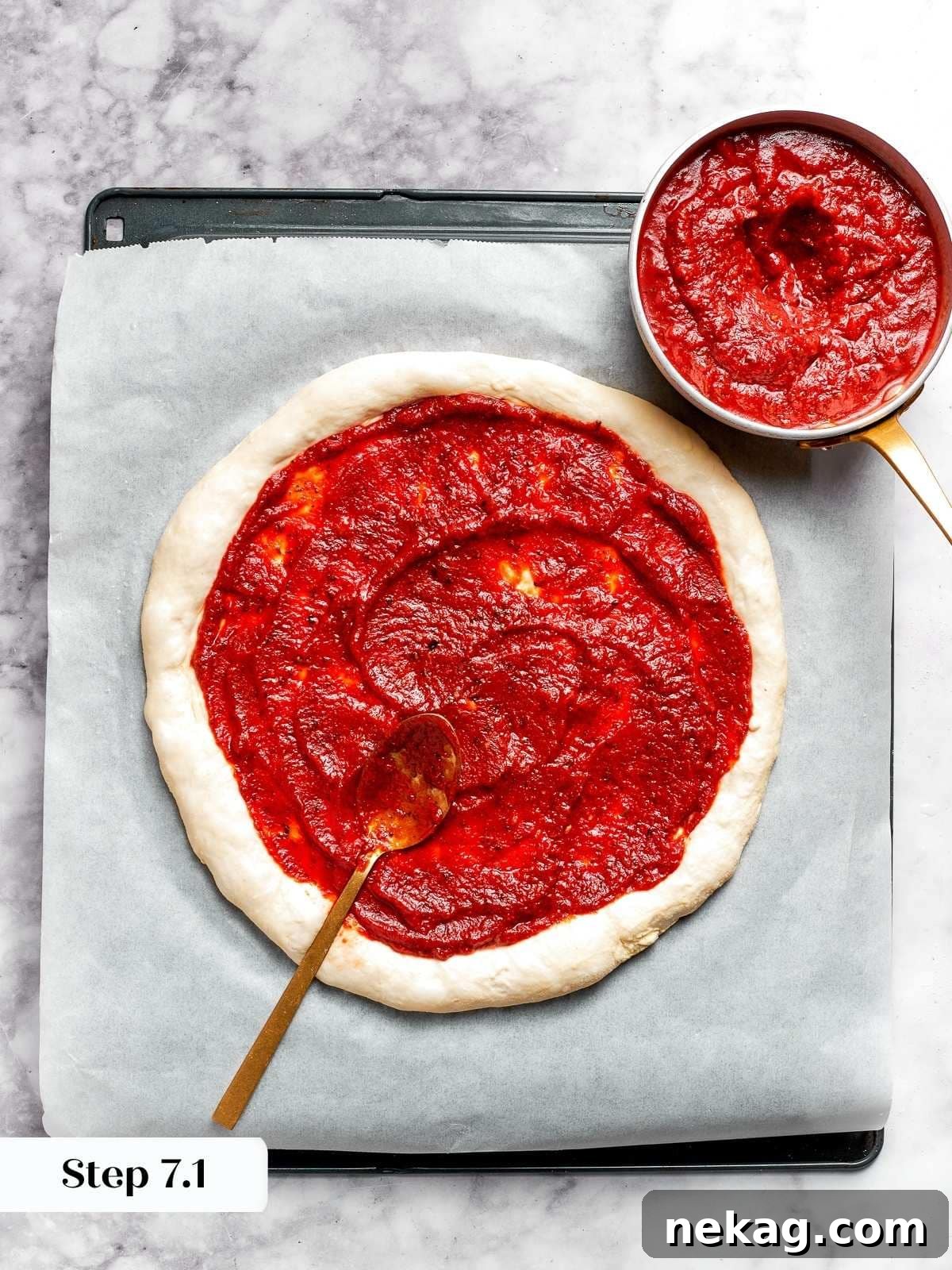 Rich tomato pizza sauce being skillfully spread onto the round pizza dough, leaving a perfect crust border.