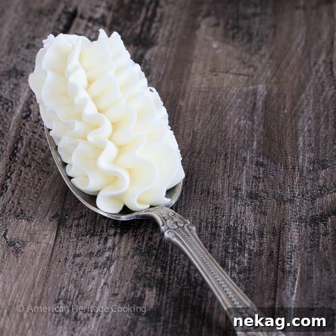 A spoonful of perfectly piped white Italian meringue buttercream, showcasing its smooth and stable consistency.