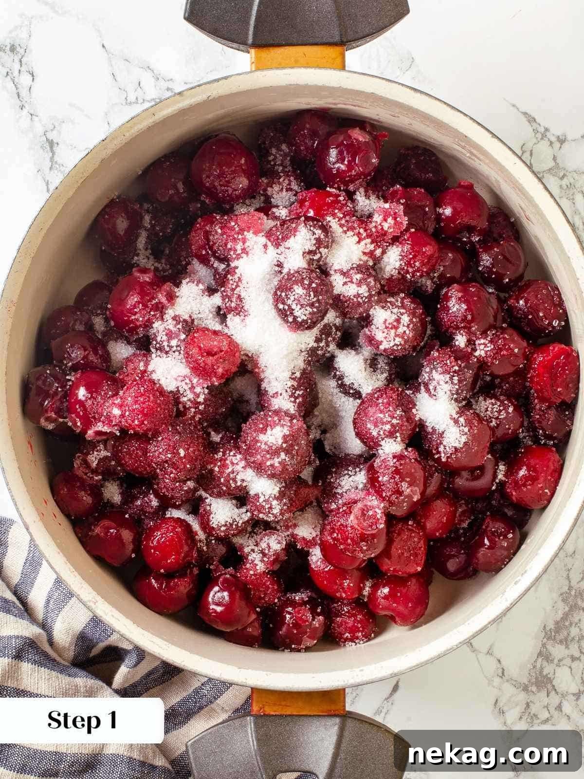 Cherries, sugar, and extract combined in a saucepan before thickening for pie filling.