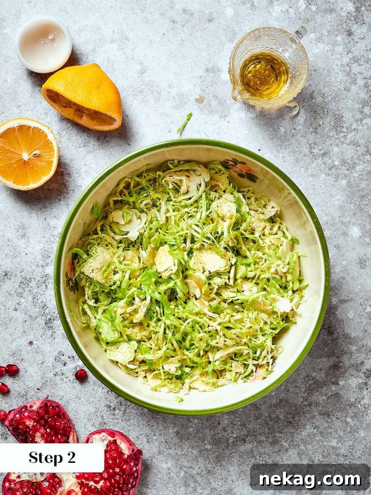 Bright lemon juice and rich olive oil being generously poured over a bowl of shredded Brussels sprouts, forming the base of the salad dressing.