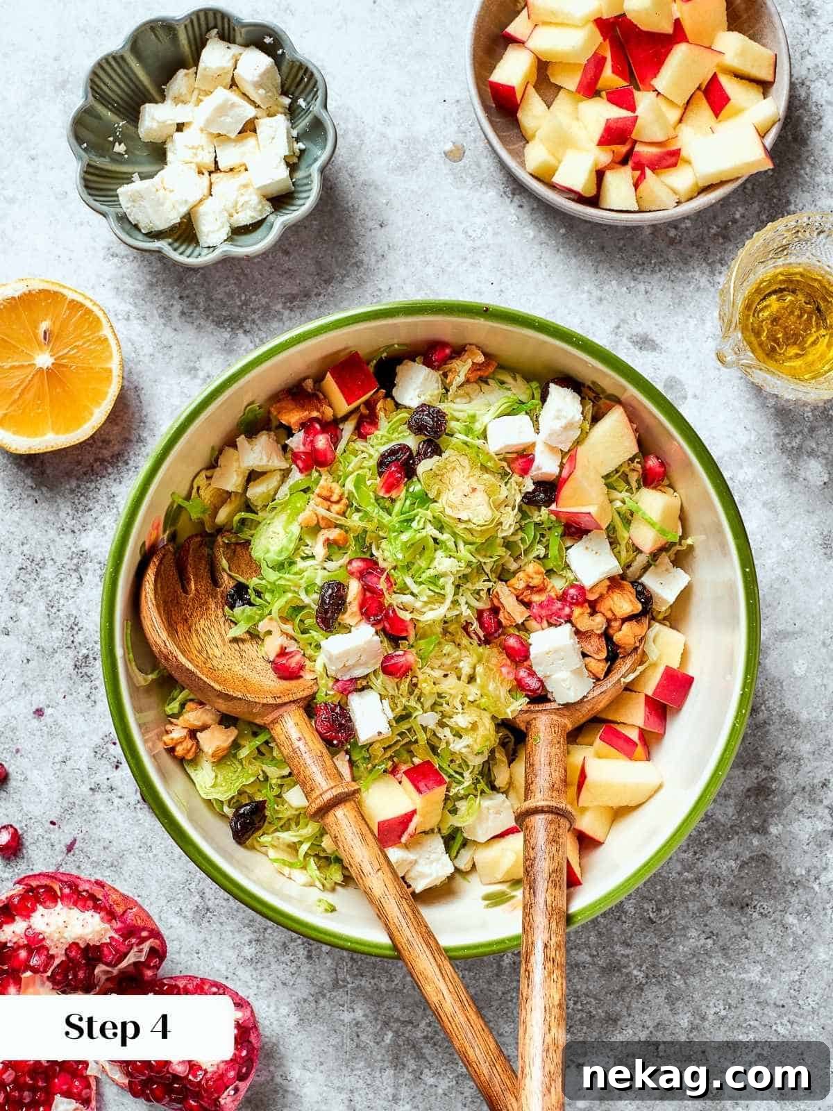 Diced pears, crumbled feta cheese, and dried fruit being added to the prepared Brussels sprouts base in a large mixing bowl, ready for tossing.