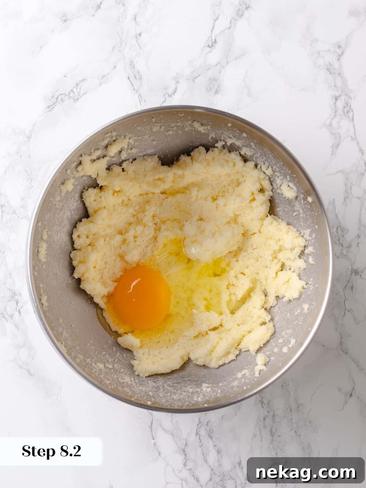 Egg is cracked and stirred into the base mixture for the topping, adding essential moisture and binding properties.