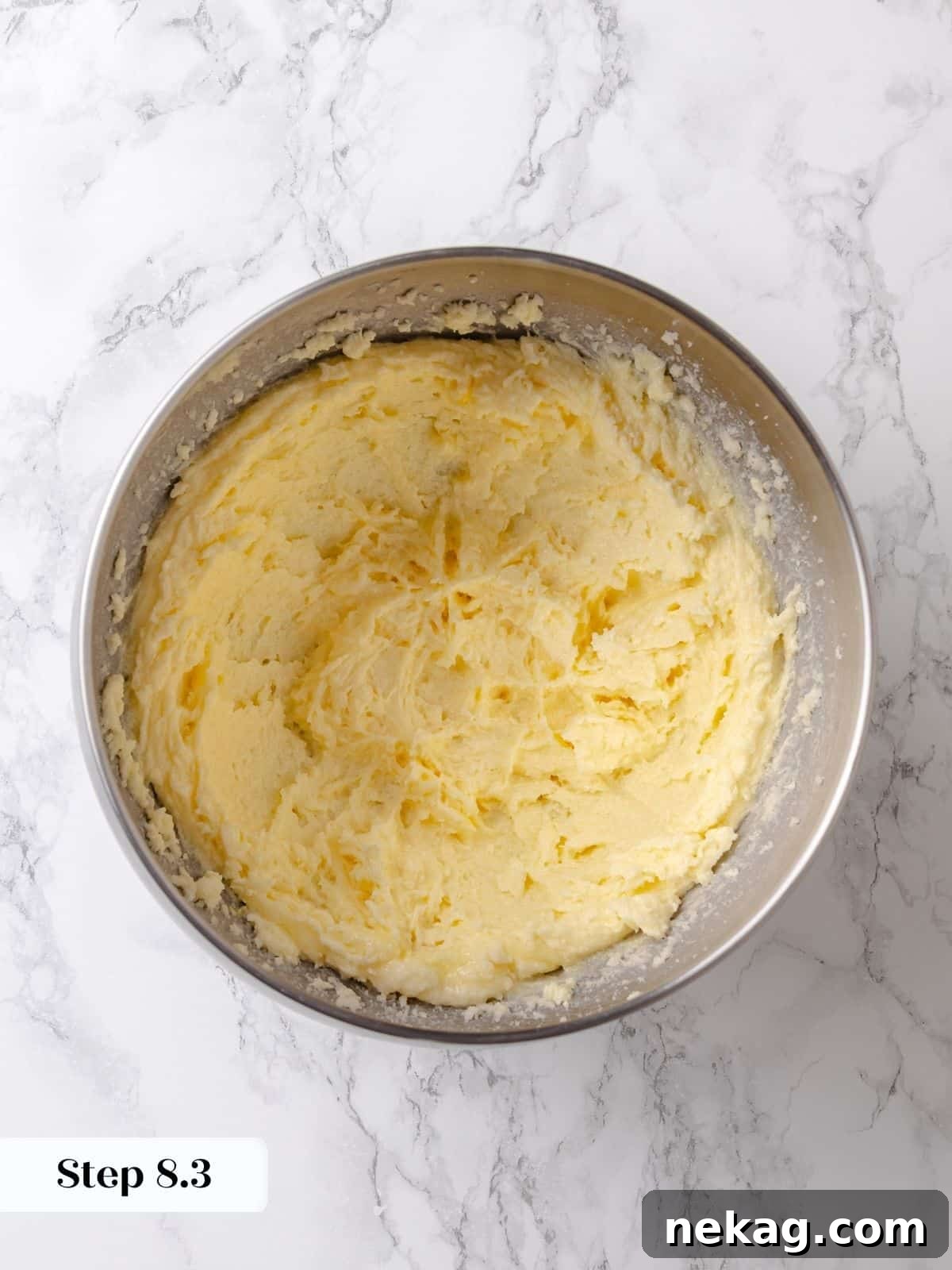Egg is thoroughly mixed into the creamed butter and sugar, creating a cohesive structure for the rich topping batter.