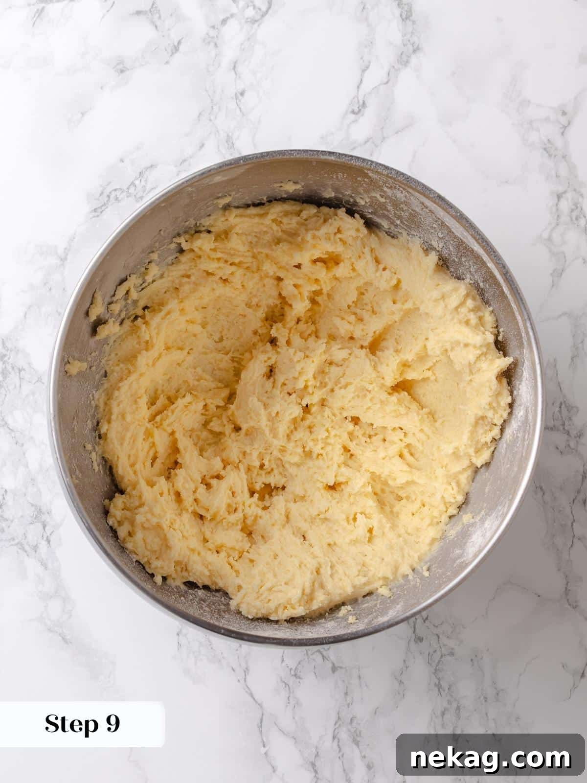 Flour and salt are incorporated into the butter and sugar mixture, forming the final structure for the sweet and gooey topping.