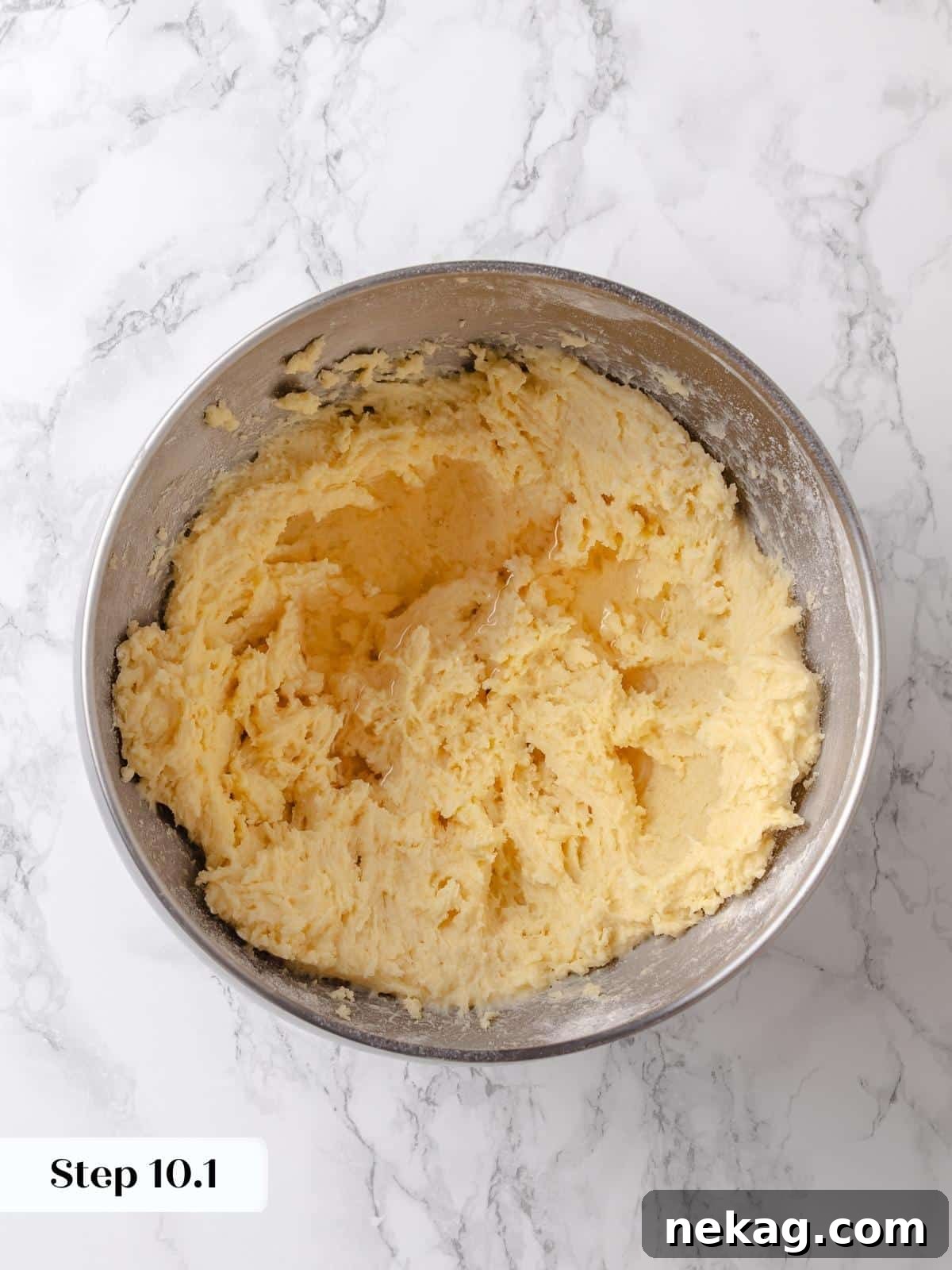 The previously prepared syrup mixture is poured into the topping batter, adding crucial moisture and sweetness before final mixing.